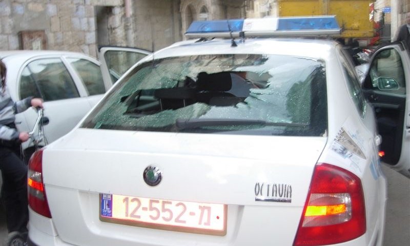 ניידת המשטרה שנרגמה באבניים. חלונות הרכב נופצו